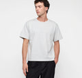 Männliches Model trägt ein graues True Extra Heavy Boxy Tee von organic basics in Misty Grey Melange mit kastenförmiger Passform.